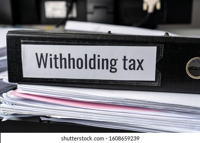 Pile of Taxation document files concept : Withholding tax, retention tax is income tax to paid to government by payer rather than by  recipient, applies to employment income, recipient's tax liability - Shutterstock ID 1608659239