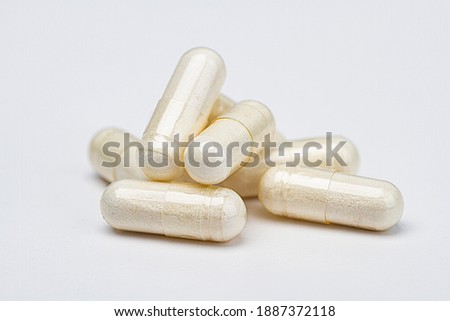 pile of transparent pill filled with white colored ingredients