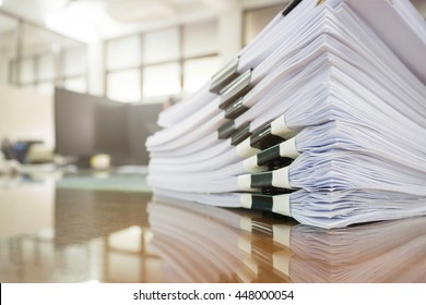Pile of unfinished documents on office desk, Stack of business paper - Shutterstock ID 448000054