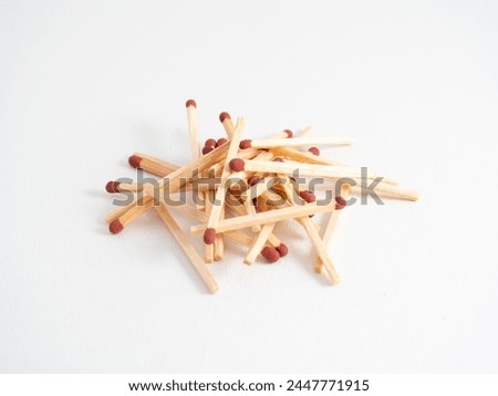 A pile of unused matches, isolated on a white background.