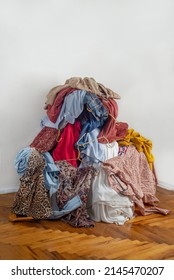 Pile with used clothes. The concept of sustainable fashion. Pile of used clothes on a light background. Second hand for recycling