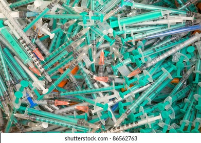 Pile of used disposable syringes