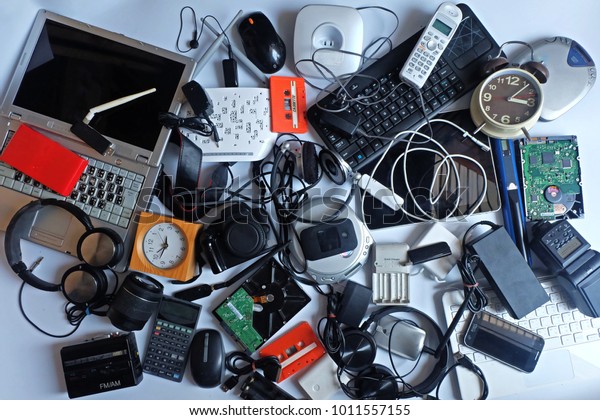 Pile of used Electronic Waste on white\
background, Reuse and Recycle concept, Top view\
