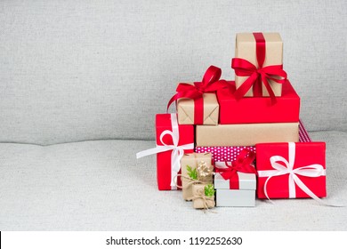 pile of various christmas and new year gift boxes collection placed on gray sofa at home - The Christmas Box Cast pile of various christmas and new year gift boxes collection placed on gray sofa at home - The Christmas Box Cast