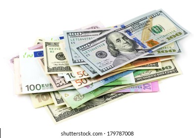 Pile of various currencies isolated on white background.