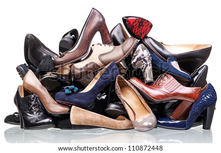 Pile of various female shoes isolated over white