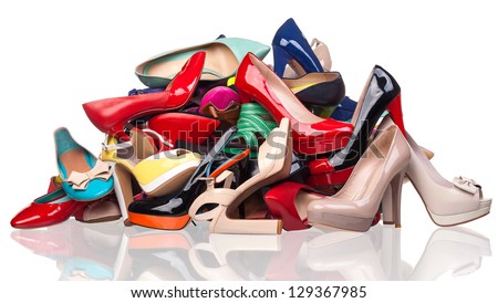 Pile of various female shoes over white
