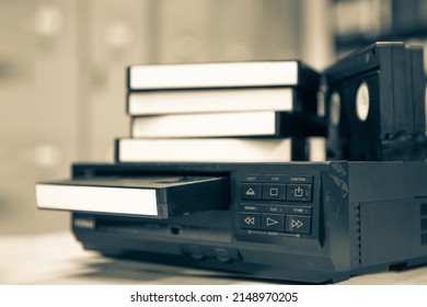 Pile of video cassette tape VHS with video playback old retro style stack concept of vintage electric and electronic appliances multimedia record player device old fashioned. - Shutterstock ID 2148970205