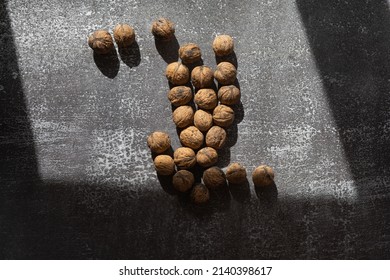 Pile Of Walnuts In Light And Shadow On Rustic Background, Still Life Food Photography