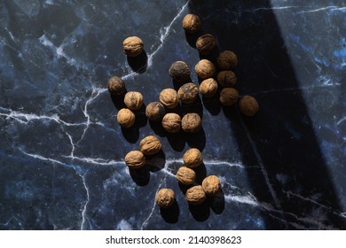 Pile Of Walnuts In Light And Shadow On Rustic Background, Still Life Food Photography