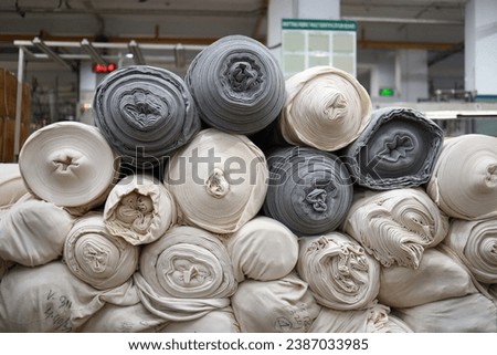A pile of white and black fabric rolls compiled. 