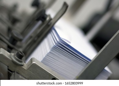 A Pile Of White Paper Envelopes In Printing Machine Ready For Printing