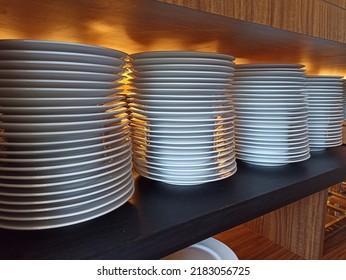 
Pile Of White Plates In Cutlery Storage Cupboard. Prepared To Serve Guests Who Will Eat At This Restaurant.

