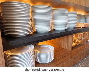 
Pile Of White Plates In Cutlery Storage Cupboard. Prepared To Serve Guests Who Will Eat At This Restaurant.