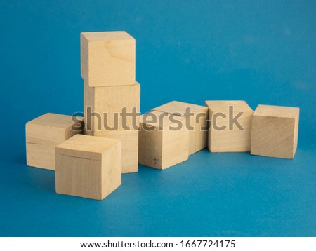 pile of wooden cubes scattered on a blue background