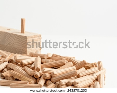 Pile of  Wooden fluted Dowel pins with wooden board isolated on a white background