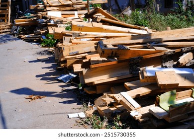 Pile of wooden packaging waste on the side of the road. Closeup shot of scattered wooden planks. Wood industry. Packaging industry. Backgrounds and wallpaper. Background Photography Concepts.  - Powered by Shutterstock