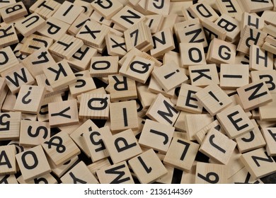 pile of wooden tiles with latin alphabet letters and characters - Shutterstock ID 2136144369
