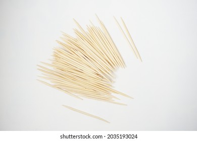 Pile of wooden toothpicks on white background isolated                               