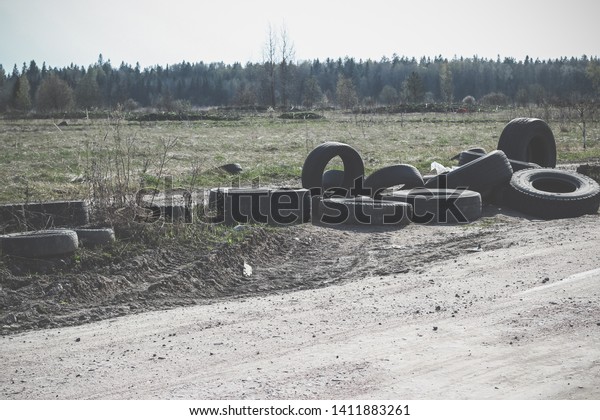 A pile of
worn car tires dumped on the field. Environmental pollution.
Landfill of used tires, car waste. Car waste recycling, automotive
industry. Rubbish along the
road