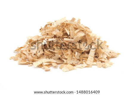 A pile of yellow sawdust wood pieces on a white background