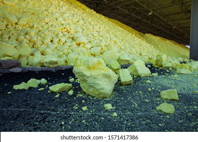 Pile Of Yellow Sulfur On Sulfuric Acid Factory Warehouse And Railway Terminal. Oil Refinery Plant. Close-up Of Sulfur Heap. (Sulphur).