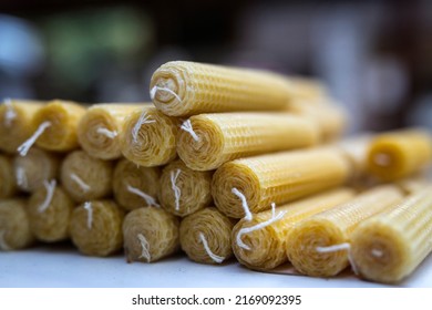 Piled Beeswax Taper Candles Close Up
