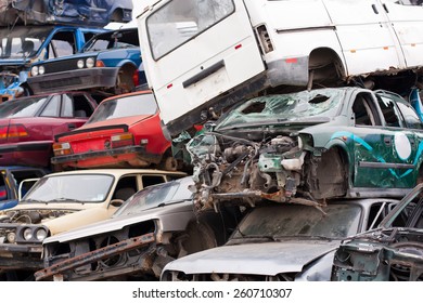 Piled up destroyed cars in the junkyard. - Shutterstock ID 260710307