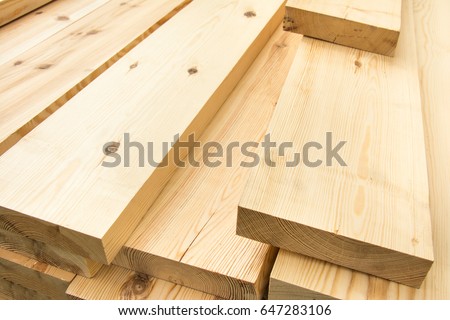 Piled lumber near a lumber mill, waiting for shipping. Wood Mill. Lumber and wood slice.