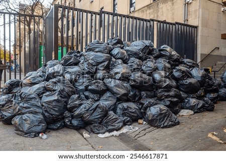 Piles of bagged trash on street in New York City waiting to be picked up.