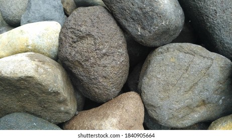 piles of beautiful river stones adorn the garden - Shutterstock ID 1840905664