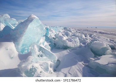 Piles Of Blue Ice Fragments Covered In Snow. Frozen Lake Baikal On A Sunny Winter Day.