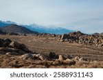 Piles of boulders in separate groups at the Alabama Hills below the Sierra Nevada.