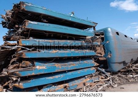 Piles of mangled metal stacked in piles after the destruction of old subway cars