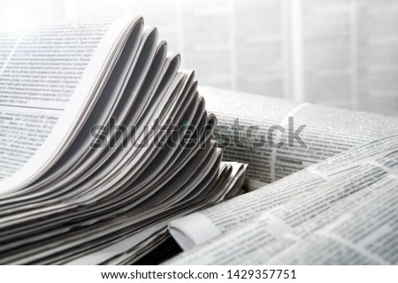 piles of numerous printed newspapers closeup