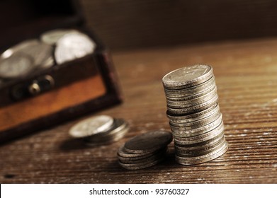 piles of old coins on wooden table