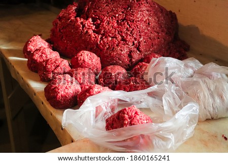 Piles of rounded ground meat ready for packaging