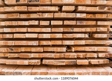 Piles of wooden boards in the sawmill, planking. Warehouse for sawing boards on a sawmill outdoors. Wood timber stack of wooden blanks construction material. Industry. - Shutterstock ID 1189076044