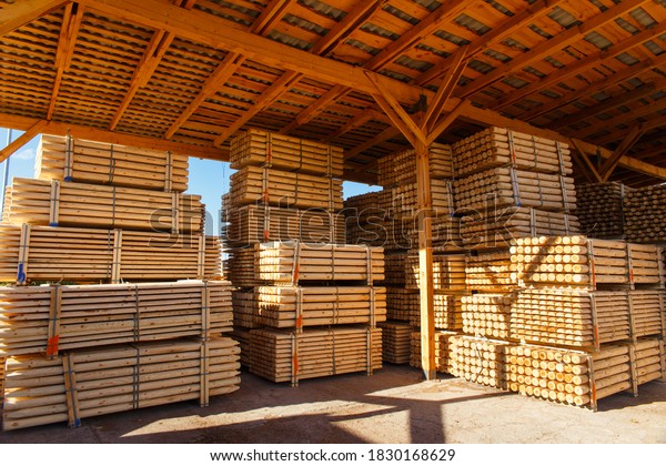 Piles of wooden\
boards in the sawmill, planking. Warehouse for sawing boards on a\
sawmill outdoors. Wood timber stack of wooden blanks construction\
material. Lumber\
Industry.