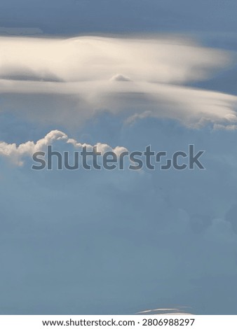 Pileus Cap Cloud with Pointed Peak Above a Growing Cumulus Tower