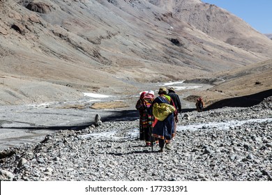 Pilgrims circumambulating Mt. Kailash by performing full body prostrations, Western Tibet