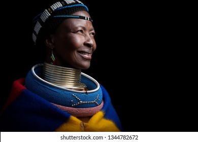 Pilgrims Rest, Mpumalanga, South Africa- July 12, 2011: An Ndebele woman poses for a portrait showing her traditional colourful clothes and intricate jewellery.