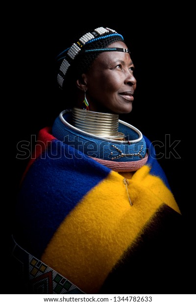 Pilgrims Rest, Mpumalanga, South\
Africa- July 12, 2011: An Ndebele woman poses for a portrait\
showing her traditional colourful clothes and intricate\
jewellery.