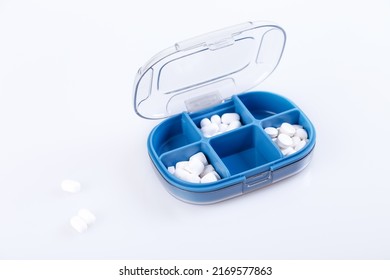 Pill Box With Colorful Pills And Vitamins. Plastic Blue Container With Cells For Medicines. Health Concept. Selective Focus, Close-up.