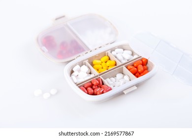 Pill Box With Colorful Pills And Vitamins. Plastic Beige Container With Cells For Medicines. Health Concept. Selective Focus, Close-up.