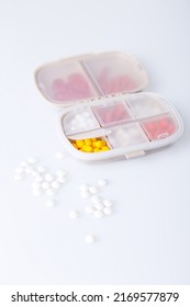 Pill Box With Colorful Pills And Vitamins. Plastic Beige Container With Cells For Medicines. Health Concept. Selective Focus, Close-up.