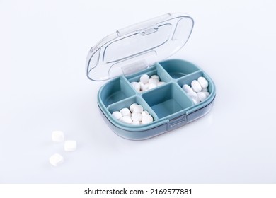 Pill Box With Colorful Pills And Vitamins. Plastic Blue Container With Cells For Medicines. Health Concept. Selective Focus, Close-up.