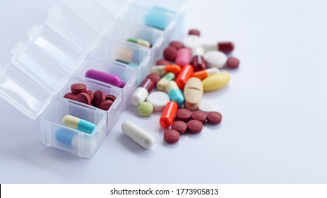 Pill box daily take a medicine, with colorful of pills, tablets, and capsules. Drugs use for treatment and cure the disease. Medication in medical clinic isolated in white background, has copy space. - Shutterstock ID 1773905813