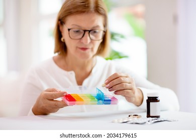 Pill Box For Senior Patient. Medicine Container. Elderly Woman Sorting Drug Pills For Pain Relief And Disease Treatment. Sick Retired Female With Drugs. Daily Vitamins For Healthy Retirement.