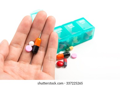 Pill In Hand And Medicine Dose Box